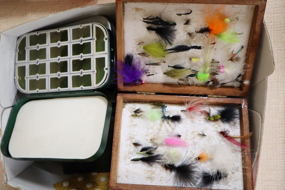 A collection of fishing flies and reels